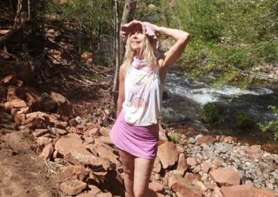 Trish Hart Lookung Upward Shading The Sun From Her Eyes